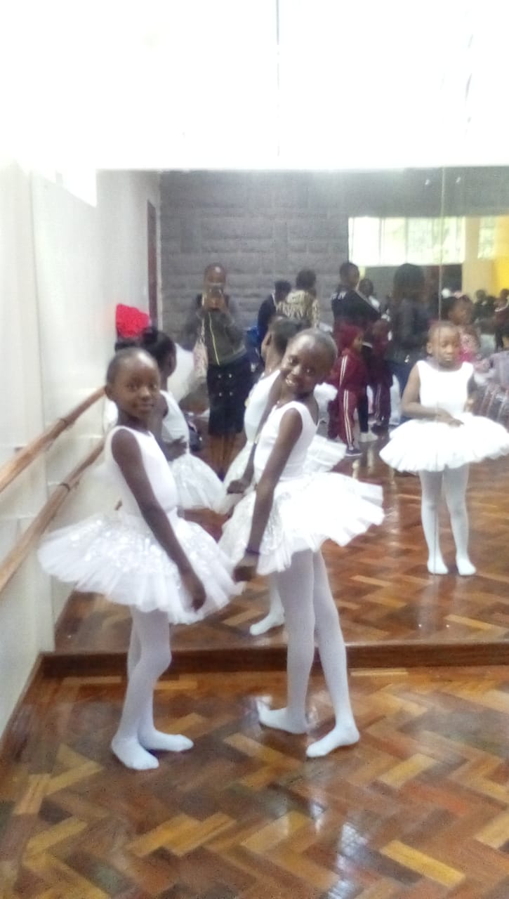 A girl in a white ballet costume during a lesson